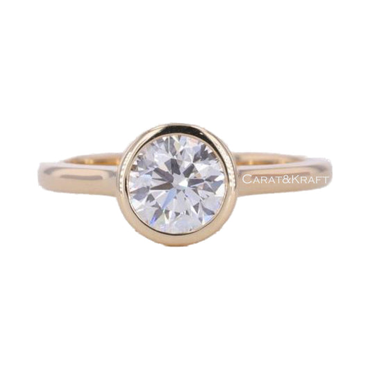 Round Moissanite Bezel Set Solitaire Engagement Ring from Carat and Kraft, on white