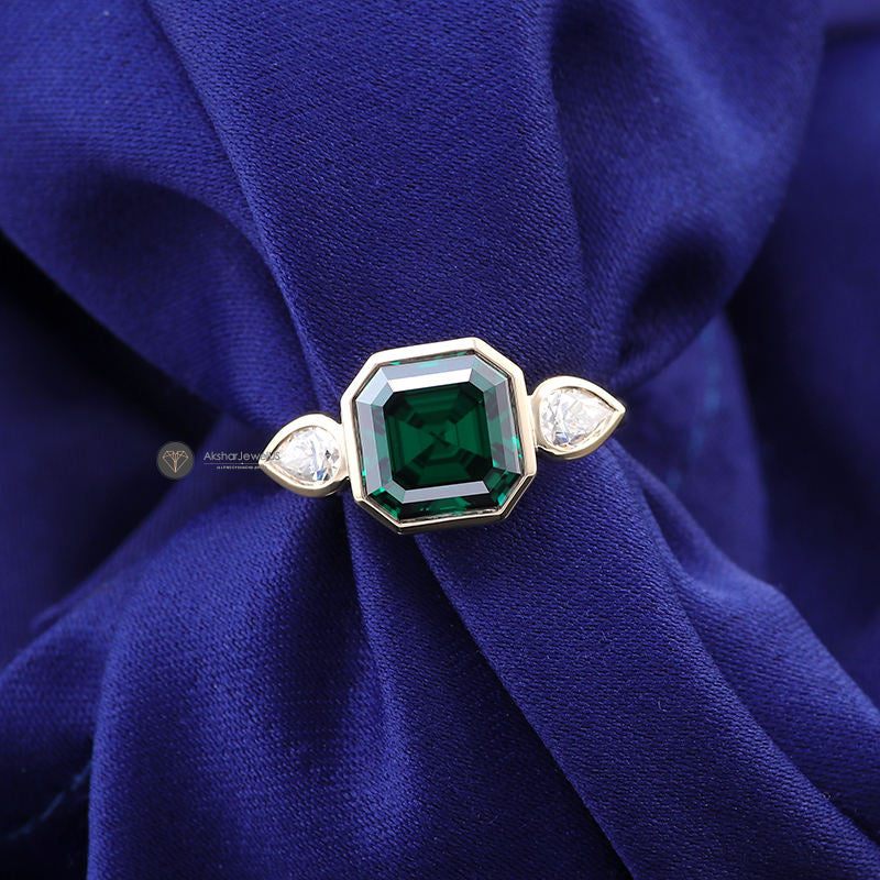 Green Emerald Asscher Moissanite Bezel Set and Pear Three Stone Ring