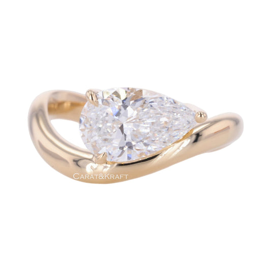 East West Pear Cut Solitaire Moissanite Diamond Engagement Ring from Carat and Kraft, on white