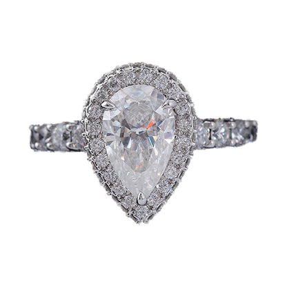 Elongated Pear Halo Moissanite Ring, Hidden Halo Wedding Ring from Carat and Kraft, on white