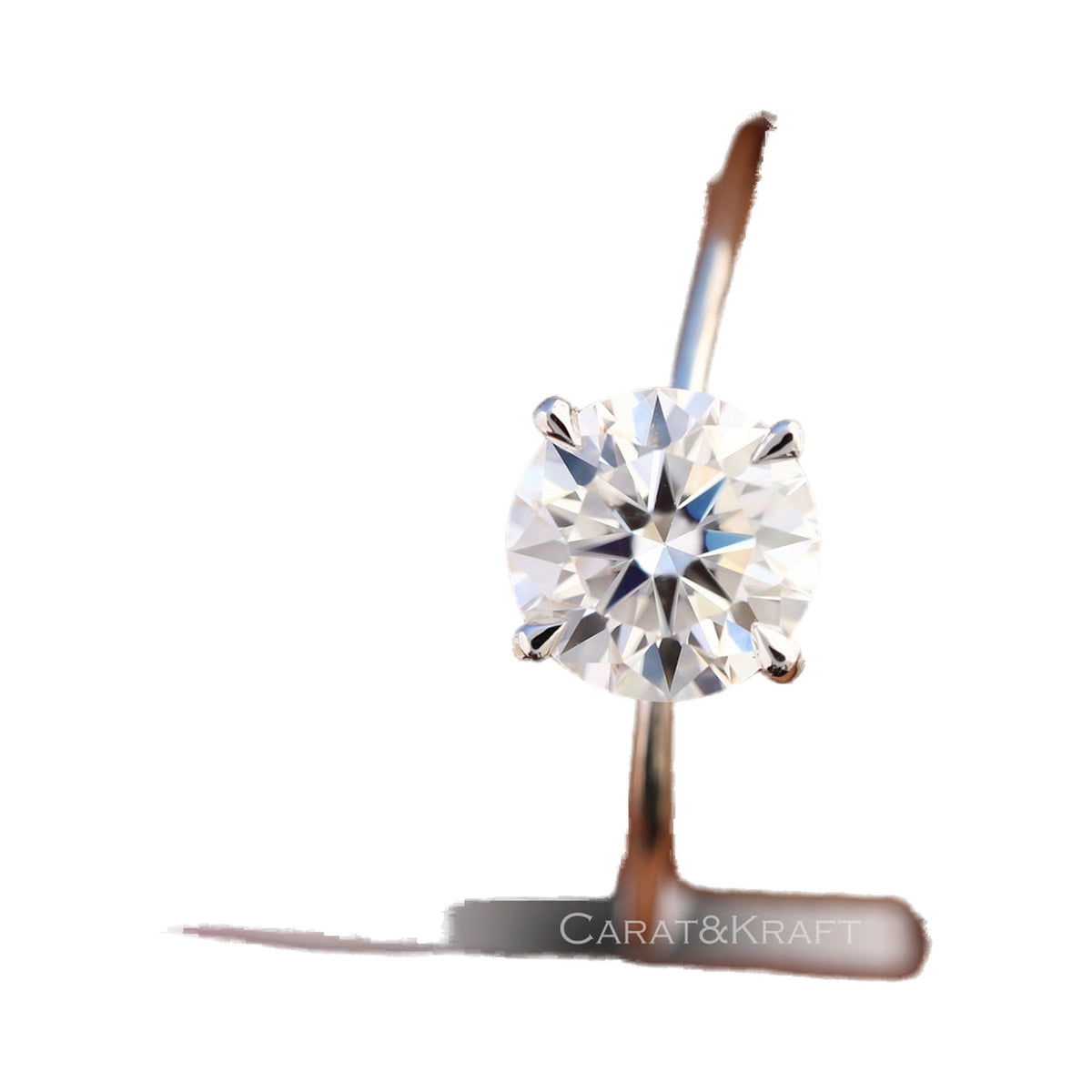 Round Cut Colorless Moissanite Solitaire Engagement Ring from Carat and Kraft, on white